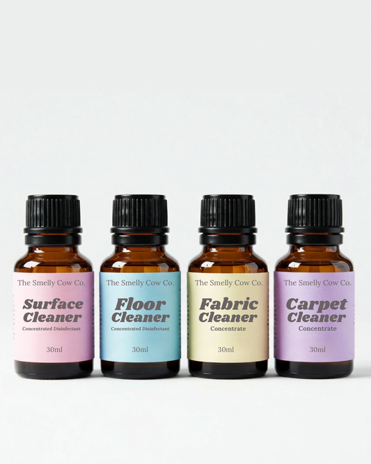 4 amber glass bottles with multiple colour labels and a different cleaning concentrate inside each.