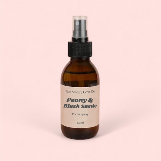 An 120ml amber bottle with peony and blush suede room spray inside.